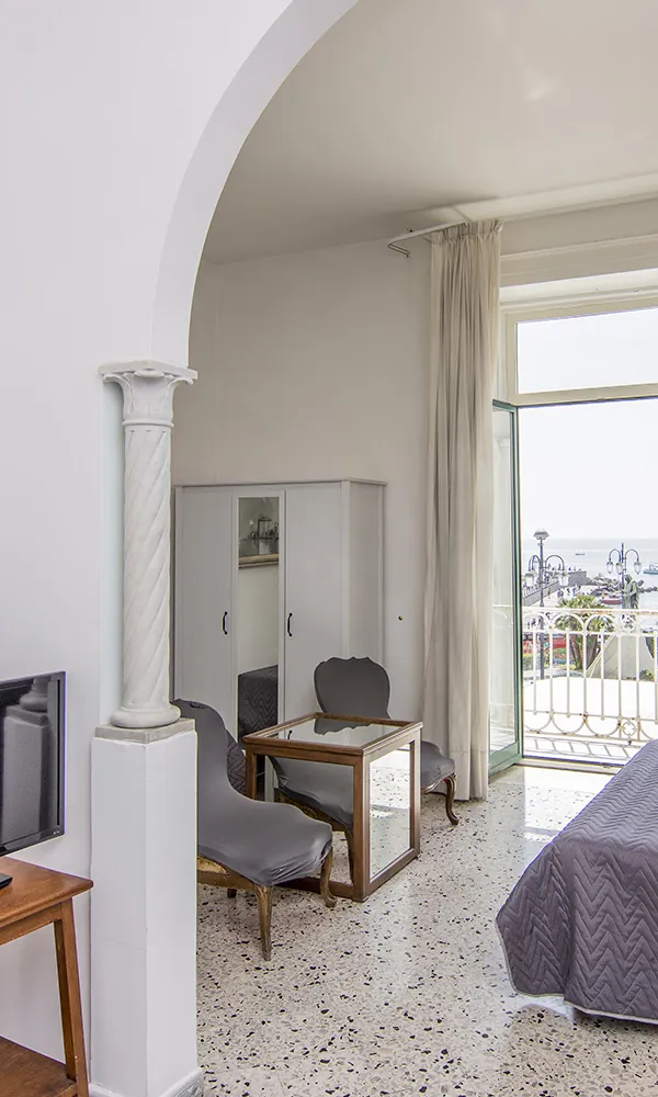 A room with a balcony over the sea